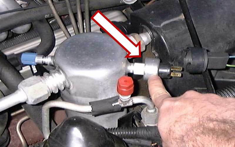 Where is the AC low-pressure switch located